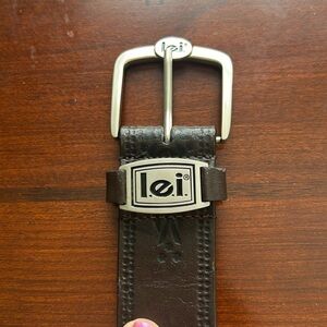Genuine leather size small belt tooled with l.e.i. On buckle & on return loop.